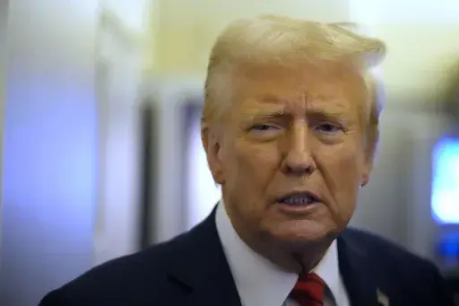 President Donald Trump speaks to reporters aboard Air Force One en route from Miami to Joint Base Andrews, Md., Monday, Jan. 27, 2025. (AP Photo/Mark Schiefelbein)