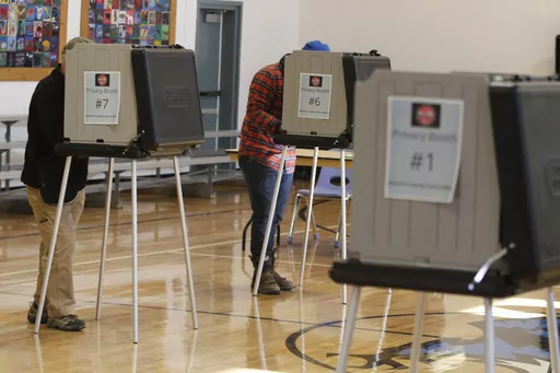 Voters fill out ballots at an elementary school in Tesuque, N.M., on Tuesday, Nov. 8, 2022. A federal judge has ruled, Tuesday, April 2, 2024, that New Mexico election regulators violated public disclosure provisions of the National Voter Registration Act in withholding voter rolls from a conservative group and its public online database. (AP Photo/Morgan Lee, File)