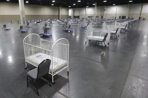 Cots and cribs are arranged at the Mountain America Expo Center in Sandy, Utah, on April 6, 2020, as an alternate care site or for hospital overflow amid the COVID-19 pandemic. According to a National Center for Health Statistics report released on Wednesday, Feb. 23, 2022, maternal mortality rates for U.S. women climbed higher in the pandemic's first year, continuing a trend that disproportionately affects Black mothers. (AP Photo/Rick Bowmer, File)