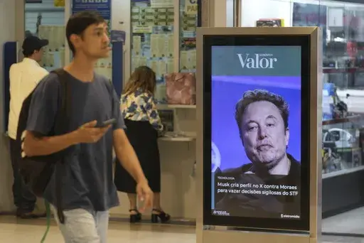 An ad by Valor media shows a photo of Elon Musk at a shopping center in Brasilia, Brazil, Monday, Sept. 2, 2024. The sign reads in Portuguese: "Musk creates profile on X against Moraes to leak confidential decisions of the Supreme Court," referring to Supreme Court Justice Alexandre de Moraes who ordered the platform blocked for having failed to name a local legal representative as required by law. (AP Photo/Eraldo Peres)