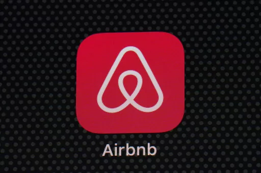 The Airbnb app icon is displayed on an iPad screen in Washington, D.C., on May 8, 2021.  NerdWallet looked at the price of 1,000 Airbnb listings and compared them to the cost of hotels. Airbnbs can be an affordable alternative to hotels, particularly for longer stays, large groups and for people who need a washer and dryer or kitchen. But beware of vacation rental cleaning fees that can make the price skyrocket, and take advantage of discounts for monthlong stays.  (AP Photo/Patrick Semansky, Fi