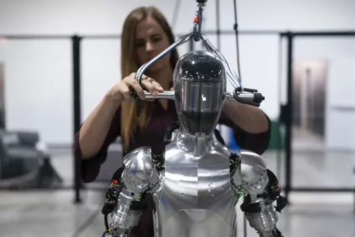 AI engineer Jenna Reher works on humanoid robot Figure 01 at Figure AI's test facility in Sunnyvale, Calif., Oct. 3, 2023. ChatGPT-maker OpenAI is looking to fuse its artificial intelligence systems into the bodies of humanoid robots as part of a new deal with robotics startup Figure. Sunnyvale, California-based Figure announced the partnership Thursday, Feb. 29, 2024, along with $675 million in venture capital funding from a group that includes Amazon founder Jeff Bezos as well as Microsoft, ch
