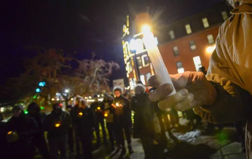 People gather in Pliny Park in Brattleboro, Vt., for a vigil, Monday, Nov. 27, 2023, for the three Palestinian-American students who were shot while walking near the University of Vermont campus in Burlington, Vt., Saturday, Nov. 25. The three students were being treated at the University of Vermont Medical Center, and one faces a long recovery because of a spinal injury, a family member said. (Kristopher Radder/The Brattleboro Reformer via AP)