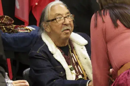 Leonard Peltier, center, a Native American activist released from a Florida prison where he had been serving a life sentence in the 1975 killings of two FBI agents, greets well-wishers during a welcome event for him, Wednesday, Feb. 19, 2025, at the Sky Dancer Casino Resort near Belcourt, N.D., on the Turtle Mountain Reservation. (AP Photo/Jack Dura)