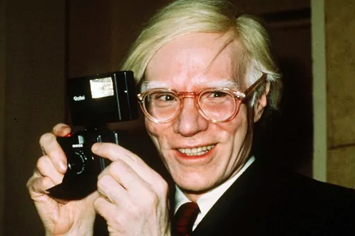 In this 1976 file photo, pop artist Andy Warhol smiles in New York. The Supreme Court on Thursday, May 18, 2023, sided with a photographer who claimed the late Andy Warhol had violated her copyright on a photograph of the singer Prince. The Supreme Court sided 7-2 with photographer Lynn Goldsmith. The case involved images Warhol created of Prince as part of a 1984 commission for Vanity Fair. Warhol used a Goldsmith photograph as his starting point. (AP Photo/Richard Drew, File)