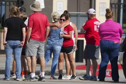 People gather for a community vigil at Tomball High School for the five members of an area family who were killed by an escaped  prisoner Friday, June 3, 2022 in Tomball, Texas. Gonzalo Lopez, a convicted murderer on the run since escaping a prison bus last month was fatally shot by law enforcement in Texas after he killed five members of the same family, including four children, and stole a truck from their rural weekend cabin, officials said. (Brett Coomer/Houston Chronicle via AP)