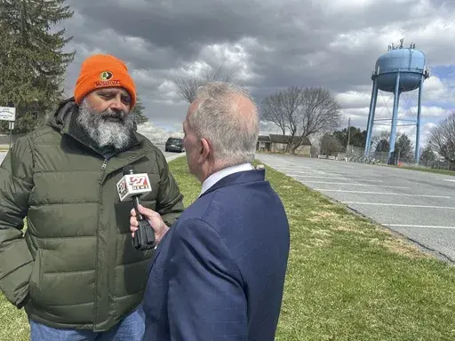 State Senate special election winner James Andrew Malone, a Democrat, does a television interview in East Petersburg, Pa., Wednesday, March 26, 2025. (AP Photo/Mark Scolforo)