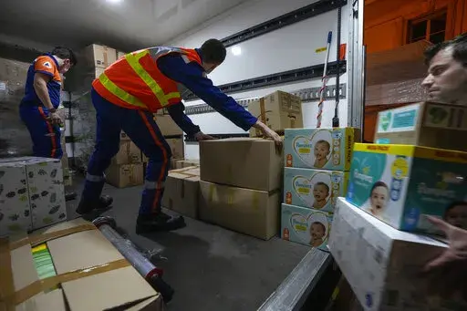 Volunteers of the civil protection load humanitarian aid onto a truck for the victims affected by the Russian invasion in Saint-Cloud, west of Paris, Thursday, March 3, 2022.   Charities say they cannot send humanitarian aid into Ukraine through normal channels, with ports blocked and roads made treacherous by bombings. Even the International Committee of the Red Cross is concerned by the conflict being carried out in densely populated areas and the dangers that poses to children, the sick and t