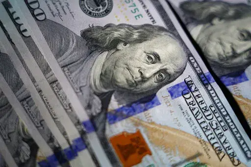 The likeness of Benjamin Franklin is seen on U.S. $100 bills, Thursday, July 14, 2022, in Marple Township, Pa. After the holiday season, those “buy now, pay later” bills will come due. If you’ve taken on too much debt or experienced a financial setback along the way, some options may provide a way out. Depending on your situation and the terms of the buy now, pay later plan, you’ll have to weigh which options save the most money to make progress on debt. (AP Photo/Matt Slocum)