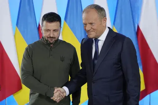 Poland's Prime Minister Donald Tusk, right, and Ukrainian President Volodymyr Zelenskyy shake hands during their meeting in Warsaw, Poland, Monday, July 8, 2024. (AP Photo/Czarek Sokolowski)