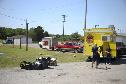 News crews film at the scene of a fatal shooting that happened at a Memorial Day event in Taft, Okla., on Sunday, May 29, 2022. (Ian Maule/Tulsa World via AP)