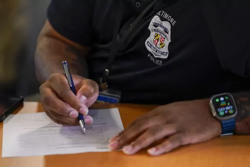 A member of the Baltimore Police Department engages in an exercise during a professional development class, Thursday, Sept. 28, 2023, in Baltimore. As law enforcement agencies across the country pursue reform measures, the Baltimore Police Department is requiring its members to complete a program on emotional regulation that teaches them the basics of brain science by examining the relationship between thoughts, feelings and actions. (AP Photo/Julio Cortez)