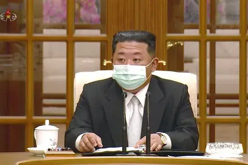In this image made from video broadcasted by North Korea's KRT, North Korean leader Kim Jong Un wears a face mask on state television during a meeting acknowledging the country's first case of COVID-19 Thursday, May 12, 2022, in Pyongyang, North Korea. North Korea imposed a nationwide lockdown Thursday to control its first acknowledged COVID-19 outbreak after holding for more than two years to a widely doubted claim of a perfect record keeping out the virus that has spread to nearly every place 