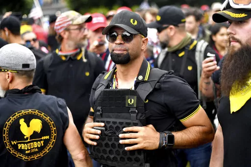 Proud Boys chairman Enrique Tarrio attends a rally in Portland, Ore., Aug. 17, 2019. Jury selection for the seditious conspiracy trial of former Proud Boys leader Enrique Tarrio and four lieutenants will resume in early January after a holiday break. The judge presiding over the case against the far-right extremist group members questioned prospective jurors for a fifth day on Friday, Dec. 23, 2022. (AP Photo/Noah Berger, File)