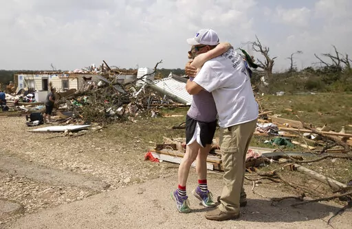 Michelle Light hugs her uncle Paul Bales on Wednesday April 13, 2022, a day after a tornado destroyed her home on FM 2843 and Cedar Valley Road near Salado, Texas. Nearly two dozen people were injured when tornadoes swept through central Texas as part of a storm system that’s expected to spawn more twisters and damaging winds Wednesday (Jay Janner/Austin American-Statesman via AP)