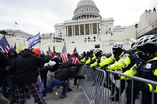 Trump supporters try to break through a police barrier at the Capitol in Washington on Jan. 6, 2021. An Alabama man who parked a pickup truck filled with weapons and Molotov cocktail components near the U.S. Capitol on the day of last year's riot was sentenced Friday, April 1, 2022, to nearly four years in prison. (AP Photo/Julio Cortez, File)