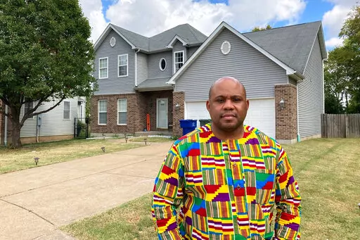 Abdul-Kaba Abdullah stands in front of his former home in St. Louis on Friday, Oct. 7, 2022. Abdullah sold the home two years ago for less than he thought it was worth after an appraisal came in lower than expected. He believes the appraisal was low because the home is in north St. Louis, a predominantly Black area of the city. St. Louis is among several U.S. cities where realtors have recently apologized for past housing discrimination and announced new efforts to protect housing rights. (AP Ph