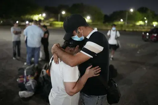 Migrants who were held in a Panamanian immigration shelter after being deported from the U.S. embraced upon arriving in Panama City on Saturday, March 8, 2025, after authorities gave them 30 days to leave the country. (AP Photo/Matias Delacroix)