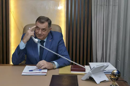 Bosnian Serb leader Milorad Dodik uses his phone prior to the start an interview with the Associated Press, in the Bosnian town of Banja Luka, 240 kms northwest of Sarajevo, Friday, Dec. 29, 2023. Bosnian Serb separatist leader wowed to carry on weakening his multiethnic, war-scarred country to the point where it will tear apart, despite the pledge by the United States to prevent such an outcome. "I am not irrational, I know that America's response will be to use force…but I have no reason to 