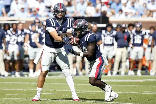 Mississippi quarterback Jaxson Dart (2) hands off the ball to running back Ulysses Bentley IV (24) during the first half of an NCAA college football game against Mississippi, Saturday, Oct. 26, 2024, in Oxford, Miss. (AP Photo/Sarah Warnock)