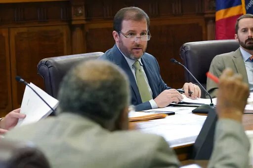 Senate Finance Committee chairman Josh Harkins, R-Flowood, acknowledges Sen. David Jordan, D-Greenwood, foreground, during a committee meeting, Tuesday, Feb. 1, 2022, at the Mississippi State Capitol in Jackson, Miss. During the meeting, Harkins unveiled a handout chart that outlined a $446.6M tax relief package. (AP Photo/Rogelio V. Solis)