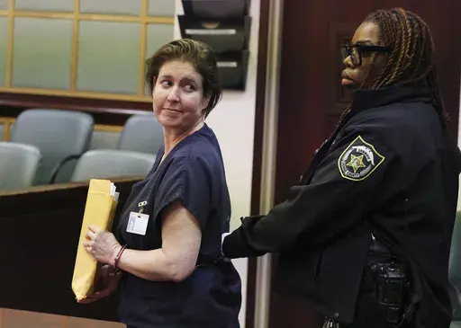 Sarah Boone is led off in handcuffs as she glances back at supporters in a courtroom of the Orange County Courthouse in Orlando, Florida, on Monday, Dec. 2, 2024. (Stephen M. Dowell/Orlando Sentinel via AP)