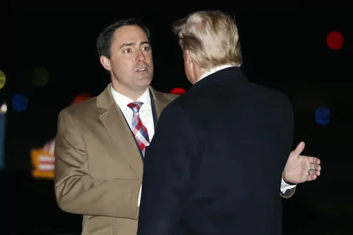 President Donald Trump greets Ohio Secretary of State Frank LaRose, Jan. 9, 2020, as he arrives at Toledo Express Airport, in Swanton, Ohio. The Republican secretaries of state in Ohio, West Virginia and Missouri all have promoted their states’ elections as fair and secure. Yet each also is navigating a fine line on how to address election fraud conspiracies, as they eye campaigns for U.S. Senate or governor in 2024. (AP Photo/ Jacquelyn Martin, File)