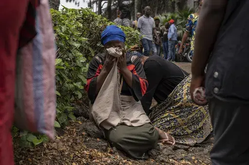 Women grieve at the port of Goma, Democratic Republic of Congo, after a ferry carrying hundreds capsized on arrival Thursday, Oct. 3, 2024. (AP Photo/Moses Sawasawa)