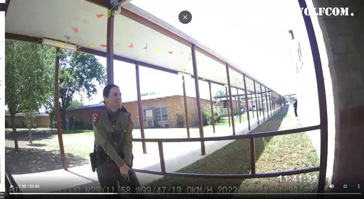 This image from video released by the City of Uvalde, Texas shows Texas Department of Public Safety trooper Crimson Elizondo responding to a shooting at Robb Elementary School, on May 24, 2022 in Uvalde, Texas.  The former Texas state trooper under investigation for the law enforcement response to the deadly school shooting in Uvalde has been hired by the school district as a campus police officer. (City of Uvalde via AP)