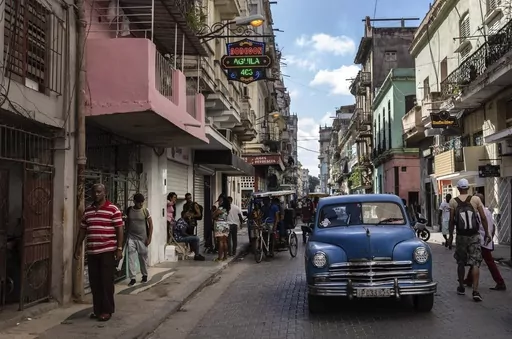 An American classic car makes its way down a street in Havana, Cuba, Nov. 11, 2023. The Cuban government says it will have to either increase prices for fuel and electricity, or reduce rations for basic supplies. President Miguel Díaz-Canel said Friday, Dec. 22, 2023, that difficult measures were needed for difficult times. (AP Photo/Ramon Espinosa, File)