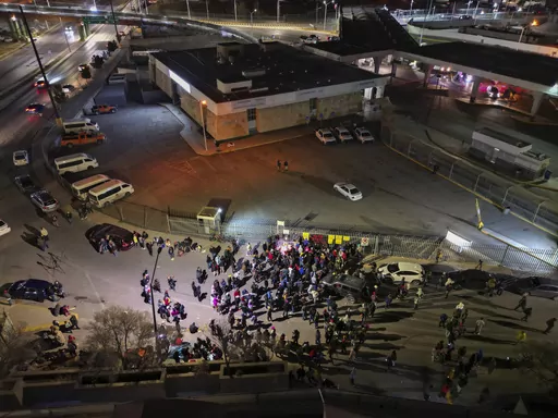 People take part in a vigil for the victims of a fire at an immigration detention center that killed dozens, outside the detention center in Ciudad Juarez, Mexico, March 28, 2023. Two guards who fled a fire that killed 40 migrants in a locked Mexican detention center did not have keys to the cell door, Mexico’s president said Tuesday, April 11, 2023. (AP Photo/Christian Chavez, File)