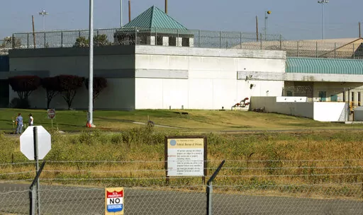 The Federal Correctional Institution is shown in Dublin, Calif., July 20, 2006. The former warden of a federal women’s prison in California will go on trial Monday, Nov. 28, 2022, after prosecutors say he sexually abused several inmates in his case, forced them to pose nude for him and kept photos of the naked prisoners on his government cellphone. Ray Garcia was the warden at the Federal Correctional Institution in Dublin, Calif. (AP Photo/Ben Margot, File)