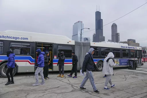 Chicago Transit Authority "warming" buses for migrants are parked in the 800 block of South Desplaines Street Thursday, Jan. 11, 2024, in Chicago. In the city of Chicago's latest attempt to provide shelter to incoming migrants, several buses were parked in the area to house people in cold winter weather. (AP Photo/Erin Hooley)