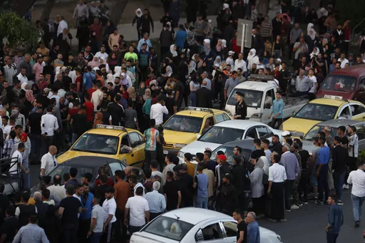 Dozens of Syrians wait at the President's Bridge in Damascus, Syria, for relatives they hope would be among those released from prison on May 3, 2022, on the second day of the Muslim Fitr holiday. The U.N. General Assembly approved Thursday, June 29, 2023, to form an independent international institution to search for the missing in Syria in both government and opposition-held areas. (AP Photo/Omar Sanadiki, File)