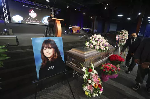 The casket containing 14-year-old Valentina Orellana-Peralta, killed on Dec. 23, 2021 by a LAPD police officer's stray bullet while shopping with her mother, is readied for her funeral at the City of Refuge Church in Gardena, Calif., Monday, Jan. 10, 2022. (AP Photo/David Swanson)