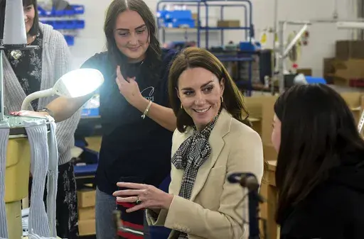 The Princess of Wales meets members of the production team during a visit to Corgi, a textiles manufacturer in Ammanford, South Wales, focused on the production of socks and knitwear, on Thursday, Jan. 30, 2025. (Rebecca Naden/PA via AP)