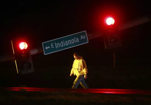 A utility worker tends to a downed stoplight on Highway 69 in Des Moines, Iowa, on Saturday, March 5, 2022, after a strong storm caused damage in areas of central Iowa. (Bryon Houlgrave/The Des Moines Register via AP)
