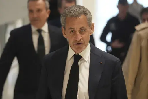Former French President Nicolas Sarkozy arrives as he goes on trial over alleged illegal financing of his 2007 presidential campaign by the government of late Libyan leader Moammar Gadhafi, Monday, Jan. 6, 2025 in Paris. (AP Photo/Thibault Camus)