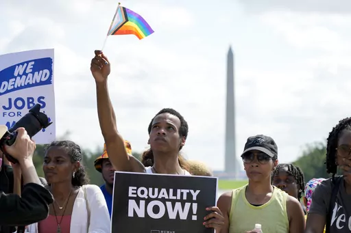People listen to speakers during the 60th anniversary of the March on Washington at the Lincoln Memorial in Washington, Aug. 26, 2023. On the 60th anniversary of the March on Washington, speakers called attention to a nationwide backlash against LGBTQ+ rights. But some Black LGBTQ+ participants felt that their early speaking slots minimized their contributions and reflected historical erasure of Black queer people in the Civil Rights Movement. (AP Photo/Jacquelyn Martin, File)