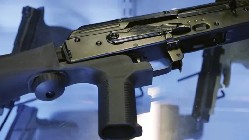 In this Oct. 4, 2017, file photo, a device called a "bump stock" is attached to a semi-automatic rifle at the Gun Vault store and shooting range in South Jordan, Utah. The Supreme Court has agreed to decide whether a ban on gun attachments that allow semi-automatic weapons to fire rapidly like machine guns violates federal law. The justices said Friday they'll hear arguments next year over a gun bump stocks regulation the Justice Department implemented after the 2017 Las Vegas mass shooting. (AP