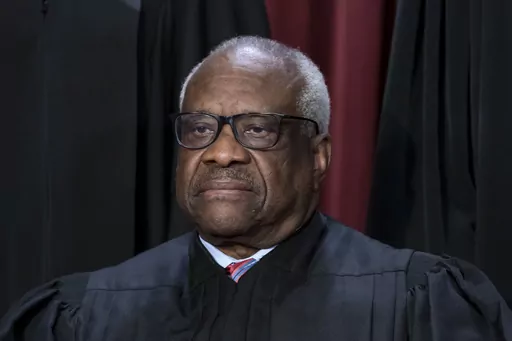 Associate Justice Clarence Thomas joins other members of the Supreme Court as they pose for a new group portrait, at the Supreme Court building in Washington, Oct. 7, 2022. Thomas said Friday, April 7, that he was not required to disclose the many trips he and his wife took that were paid for by Republican megadonor Harlan Crow. The nonprofit investigative journalism organization ProPublica reported Thursday that Thomas, who has been a justice for more than 31 years, has for more than two decade