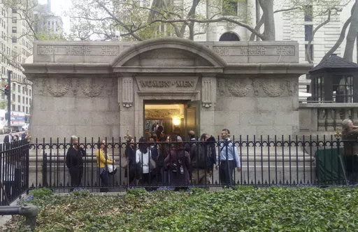 People line up to use a free public restroom, April 27, 2017, in New York. New York City Mayor Eric Adams announced Monday, June 3, 2024, a plan to build 46 new restrooms and renovate 36 existing ones located in city parks, adding to the city's roughly 1,000 such facilities over the next five years. (AP Photo/Verena Dobnik, File)