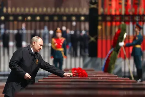 Russian President Vladimir Putin attends a wreath-laying ceremony at the Tomb of the Unknown Soldier after the military parade marking the 77th anniversary of the end of World War II in Moscow, Russia, Monday, May 9, 2022. (Anton Novoderezhkin, Sputnik, Kremlin Pool Photo via AP)