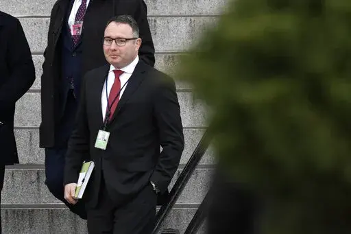 In this Jan. 27, 2020, file photo Army Lt. Col. Alexander Vindman, a military officer at the National Security Council who testified during the impeachment hearings on Capitol Hill, walks down the steps of the Eisenhower Executive Office Building on the White House complex in Washington. Vindman who was a pivotal witness in the first impeachment case against Donald Trump has sued the oldest son of the former president and other Trump allies, accusing them of participating in an “intentional, c