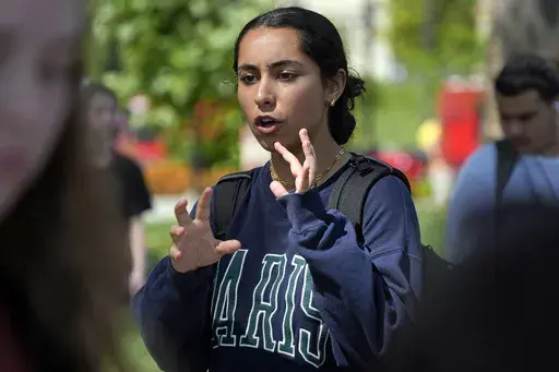 University of Pittsburgh freshman Teba Latef, center, talks with a reporter on campus in Pittsburgh, Thursday, Sept. 12, 2024. (AP Photo/Gene J. Puskar)