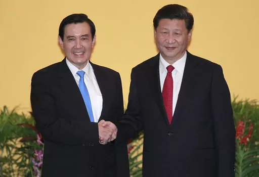 Then Taiwan's President Ma Ying-jeou, left, and China's President Xi Jinping shake hands at the Shangri-la Hotel on Nov. 7, 2015, in Singapore. Former Taiwan President Ma will visit China next week, in what a spokesman called an independent bid to ease tensions between the self-ruled island and the mainland. Ma, who's a member of the opposition Nationalist Party (Kuomingtang), will lead a delegation of academics and students as well as his former presidential staffers from March 27 to April 7, h