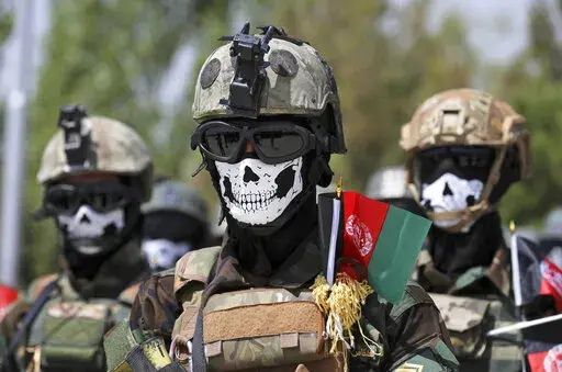 New Afghan Army special forces members attend their graduation ceremony after a three-month training program at the Kabul Military Training Center (KMTC) in Kabul, Afghanistan, Saturday, July 17, 2021. Afghan special forces soldiers who fought alongside American troops and then fled to Iran after the chaotic U.S. withdrawal last year are now being recruited by the Russian military to fight in Ukraine, three former Afghan generals told The Associated Press. (AP Photo/Rahmat Gul, File)
