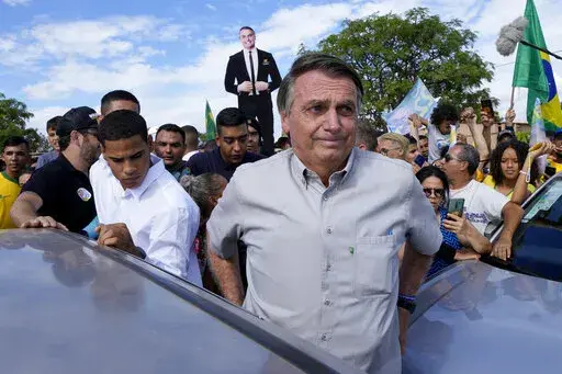 Brazil's President Jair Bolsonaro campaigns at the rural workers' settlement Nova Jerusalem, or New Jerusalem, in Brasilia, Brazil, Monday, Oct. 24, 2022. Bolsonaro is running for reelection in the presidential runoff set for Oct. 30. (AP Photo/Eraldo Peres)