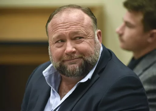 Infowars founder Alex Jones appears in court to testify during the Sandy Hook defamation damages trial at Connecticut Superior Court in Waterbury, Conn., on Sept. 22, 2022. Lawyers for several Sandy Hook families are criticizing Alex Jones' personal spending as they seek nearly $1.5 billion they won in lawsuits against the Infowars host, for his calling the 2012 Newtown school shooting that killed 26 a hoax. (Tyler Sizemore/Hearst Connecticut Media via AP, Pool, File)