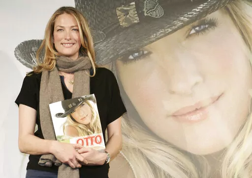 German model Tatjana Patitz poses with the new catalog of German catalog company Otto during a photocall in Hamburg, Germany, on Thursday, Dec. 14, 2006. Patitz, one of an elite group of famed supermodels who graced magazine covers in the 1980s and ’90s and appeared in George Michael's “Freedom! '90” music video, has died at age 56. (AP Photo/Fabian Bimmer, File)